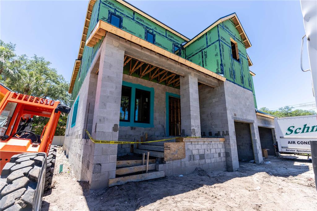 A two-story house under construction features concrete block walls, green sheathing, and a front porch — 4316 W CORONA STREET, TAMPA, FL