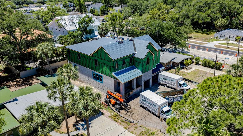 An aerial view shows a two-story house under construction with green sheathing and roofing — 4316 W CORONA STREET, TAMPA, FL