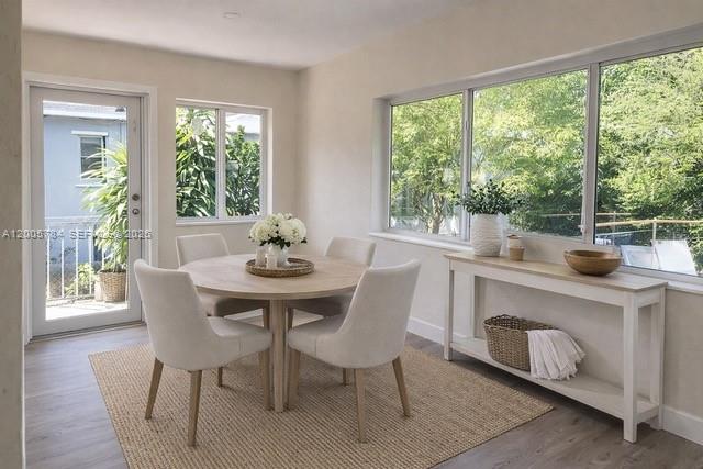 A dining area features a round wooden table, four upholstered chairs, and a console table — 815 NE 134th St, North Miami FL 33161, NORTH MIAMI, FL