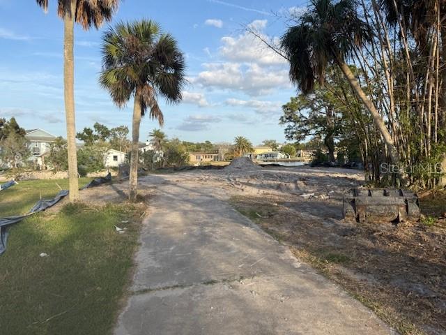 A cleared, sandy residential lot features palm trees and a concrete driveway — 5250 MILLER BAYOU DRIVE, PORT RICHEY, FL