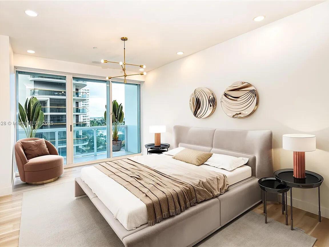 A modern bedroom features a gray upholstered bed, two circular wall art pieces, and balcony access — 10101 Collins Avenue # 7d, Bal Harbour FL 33154, BAL HARBOUR, FL