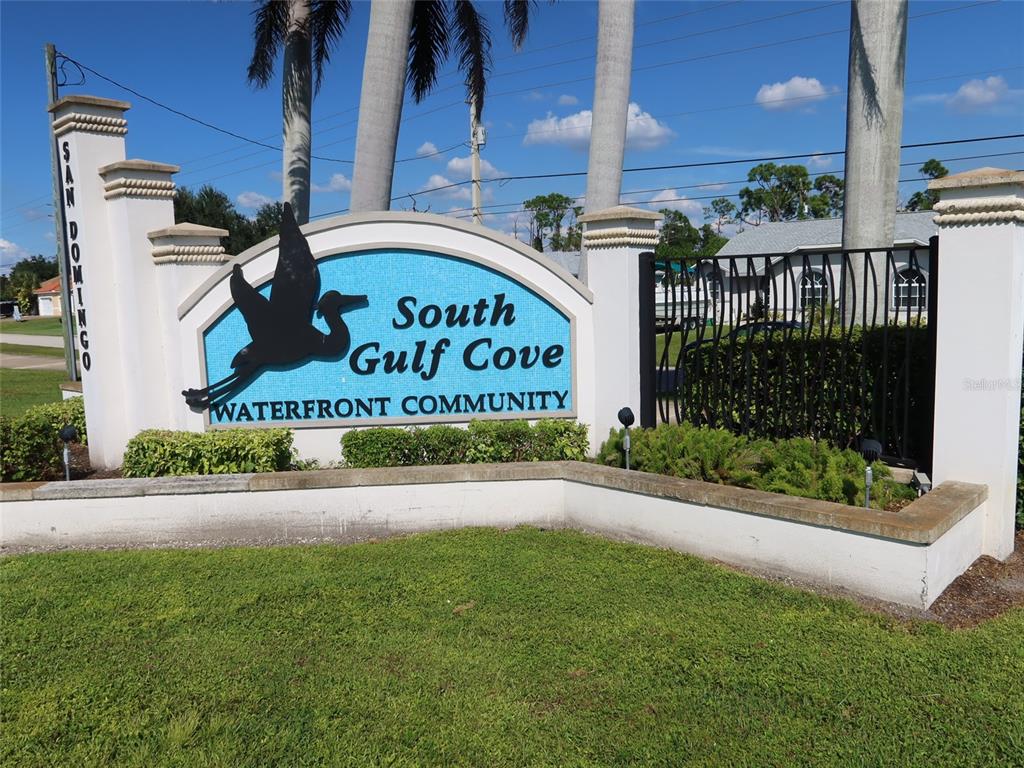 A sign for the South Gulf Cove waterfront community stands in front of palm trees — 8178 DIMSTEAD STREET, PORT CHARLOTTE, FL
