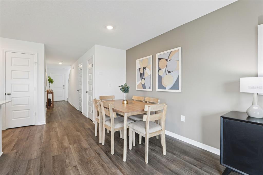 A dining area features a wooden table with four chairs against a gray accent wall — 4351 BUTTERSCOTCH CIRCLE, LAKELAND, FL