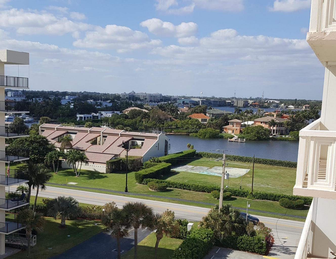 A high-angle view shows a coastal residential area with a road, canal, and apartment buildings — 3450 S Ocean Boulevard # 6190, Palm Beach FL 33480, PALM BEACH, FL