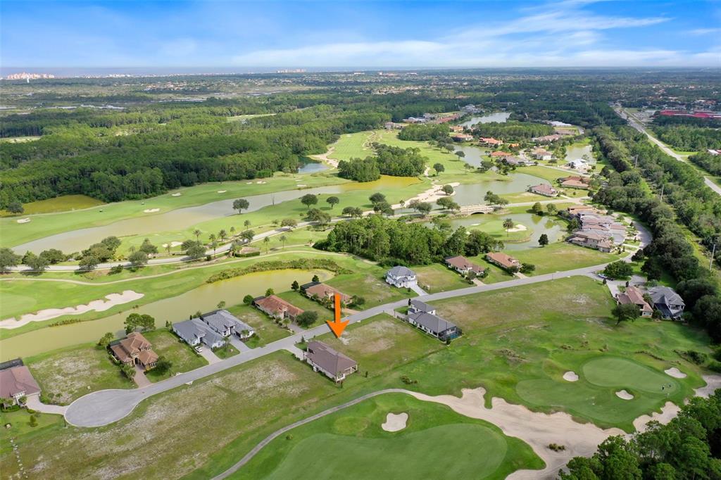 An aerial view shows a vacant residential lot situated along a golf course and pond — 342 HIBISCUS WAY, PALM COAST, FL
