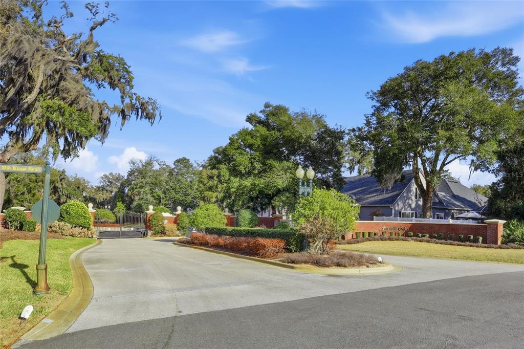A gated entrance with a brick wall and landscaping leads to a residential community — 7 SAINT CHARLES PLACE, FLAGLER BEACH, FL