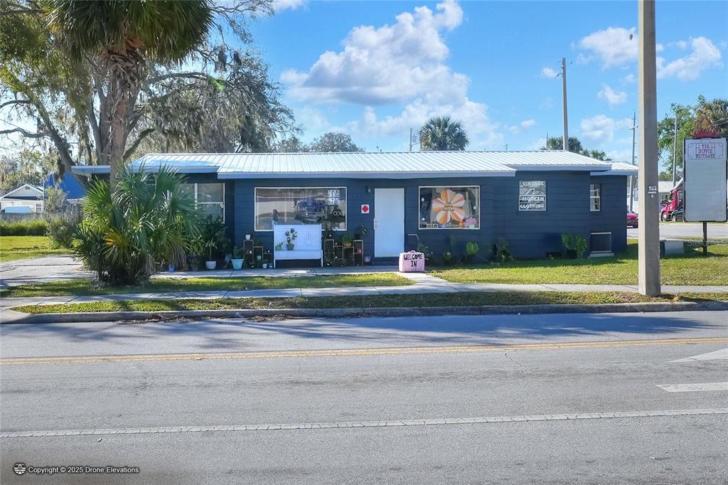 A single-story blue commercial building with a metal roof and a front display window — 300 1ST STREET S, WINTER HAVEN, FL