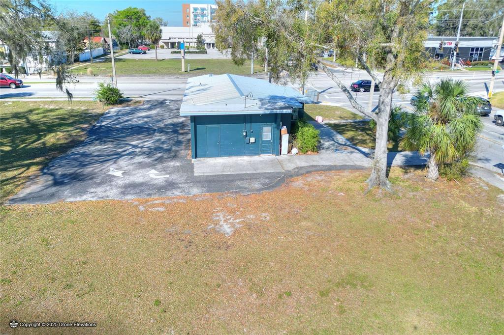 An aerial view shows a small, dark blue commercial building with a metal roof — 300 1ST STREET S, WINTER HAVEN, FL