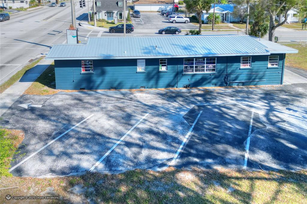An aerial view of a blue commercial building with a metal roof and parking lot — 300 1ST STREET S, WINTER HAVEN, FL