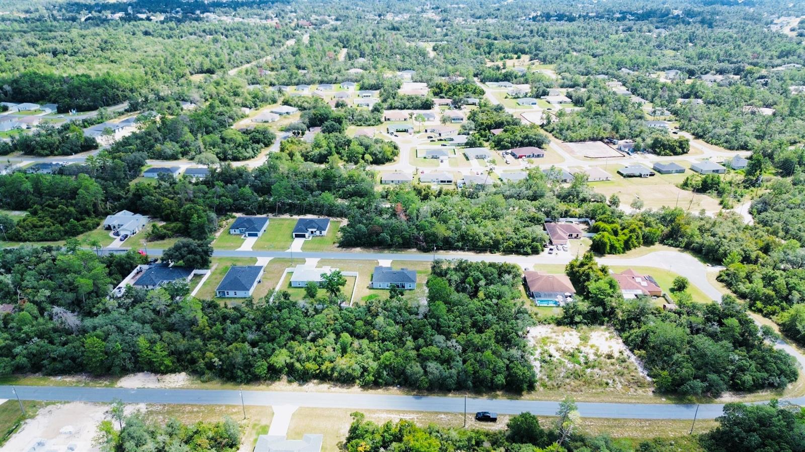 An aerial view shows a suburban neighborhood with scattered houses surrounded by dense green trees — Tbd SW 37th Avenue, Ocala FL 34473, OCALA, FL