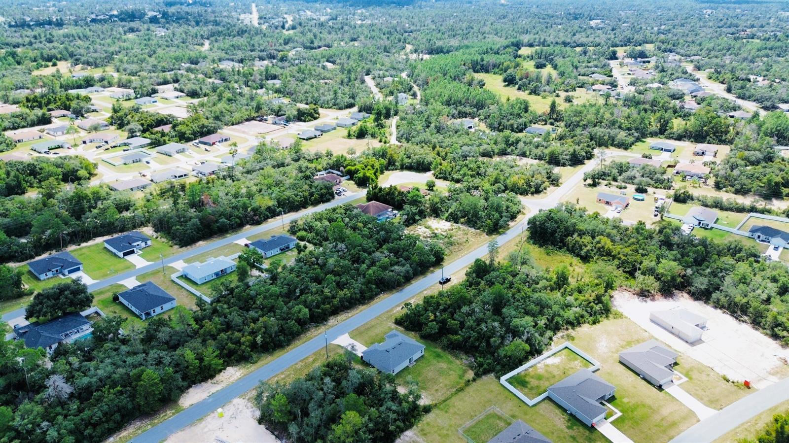 An aerial view shows a suburban neighborhood with houses, paved roads, and surrounding wooded areas — Tbd SW 37th Avenue, Ocala FL 34473, OCALA, FL