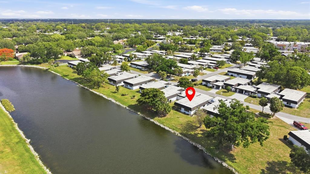 An aerial view shows a single-story residential building with a red pin near a lake — 3960 LAKESIDE ROAD UNIT 156, SARASOTA, FL