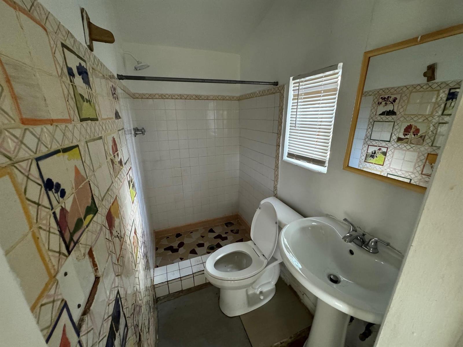 A small bathroom features a pedestal sink, a toilet, and a tiled walk-in shower area — 8261 NW 1st Place # 3, Miami FL 33150, MIAMI, FL