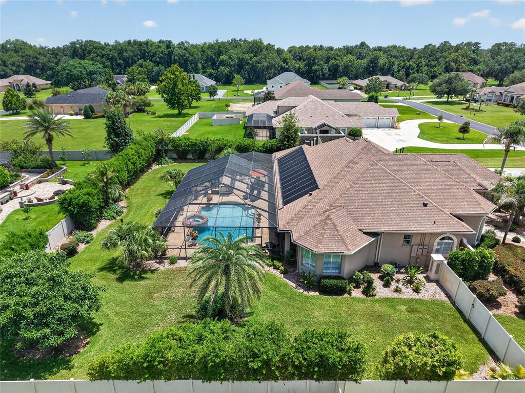 An aerial view of a house with a screened-in pool, solar panels, and a large yard — 3986 SE 43RD CIRCLE, OCALA, FL