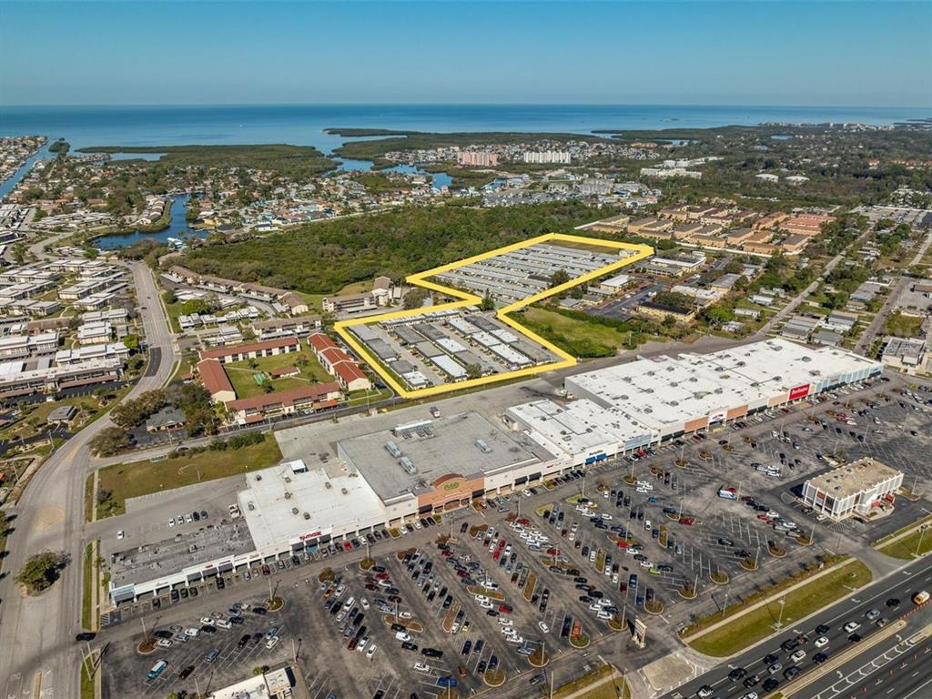 Aerial view of a shopping center with a highlighted residential complex in the background — 4954 BITNER STREET, NEW PORT RICHEY, FL