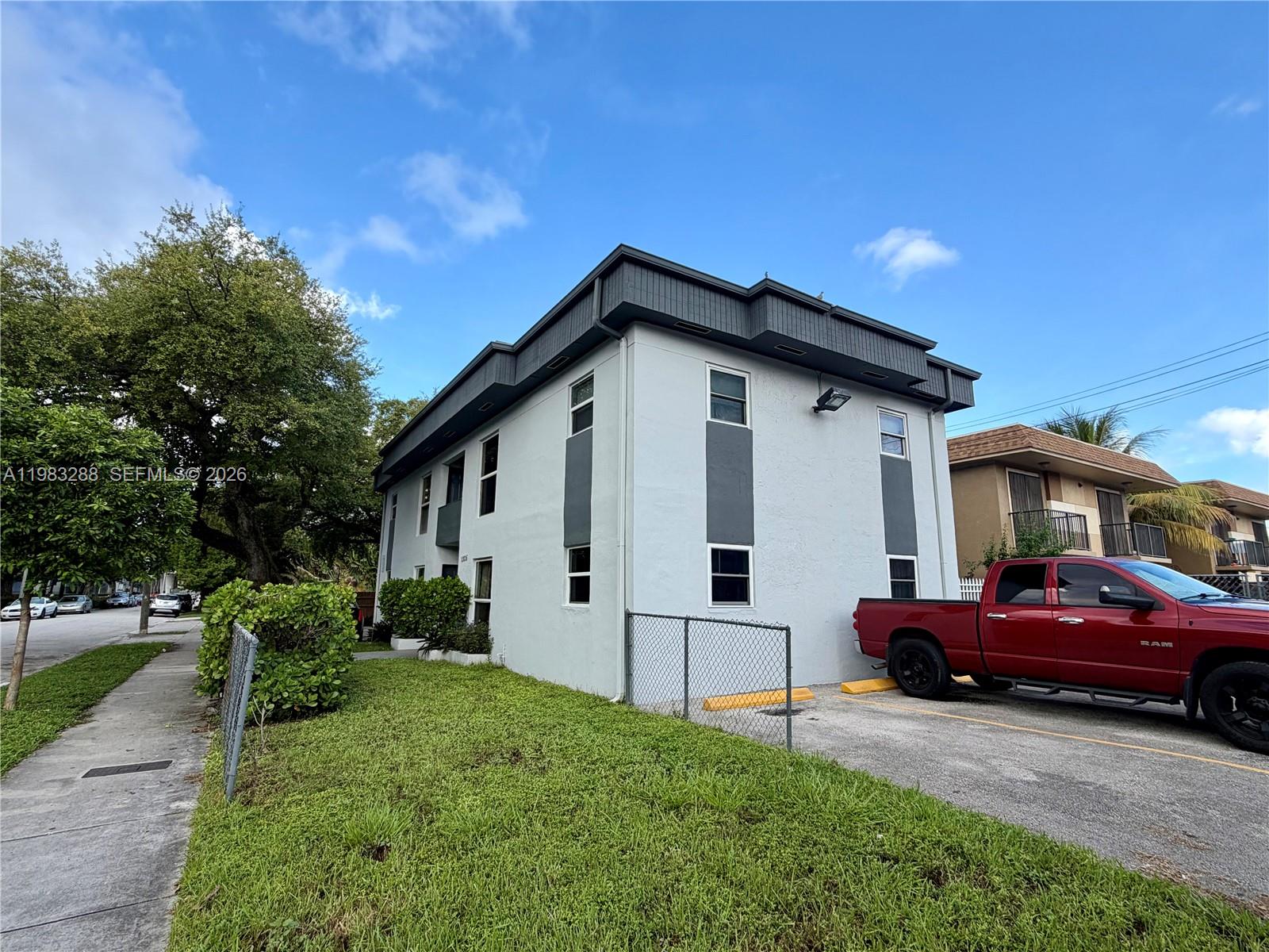 A two-story apartment building with a red pickup truck parked in the side lot — 1305 NW 4th St # 3, Miami FL 33125, MIAMI, FL
