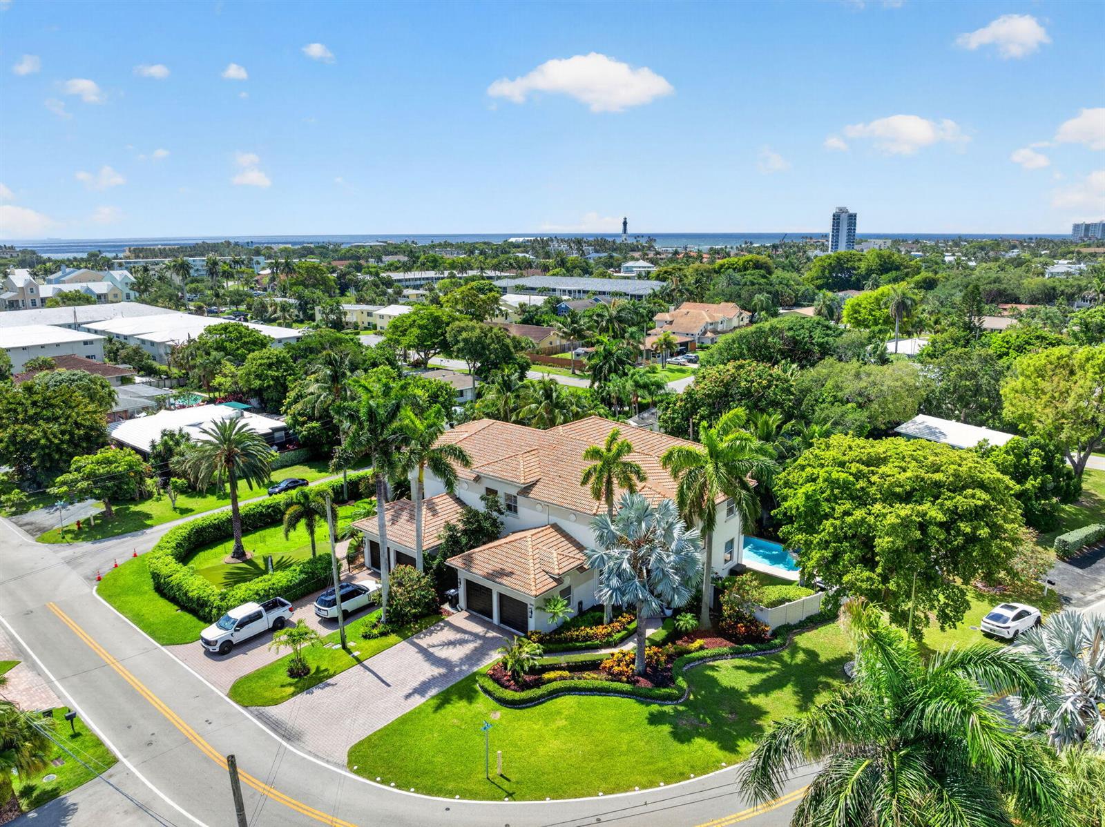 An aerial view of a two-story house with a tiled roof, pool, and palm trees — 2844 NE 26th Avenue, Lighthouse Point FL 33064, LIGHTHOUSE POINT, FL