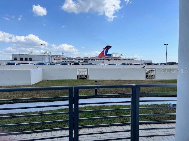 A view from a balcony overlooking a parking lot and a cruise ship — 1209 E CUMBERLAND AVENUE UNIT 508, TAMPA, FL