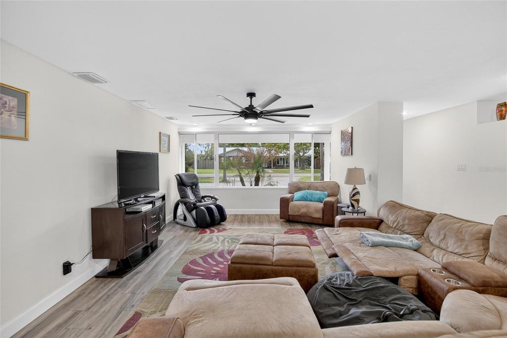 A living room features a large sectional sofa, a television console, and a ceiling fan — 723 W PINEDALE DRIVE, PLANT CITY, FL