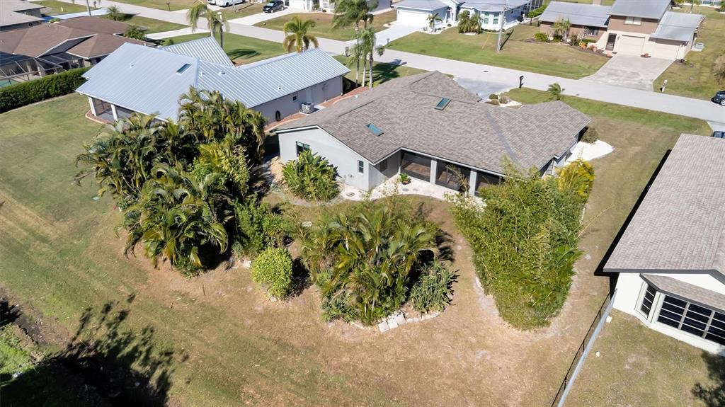 An aerial view of a suburban house with a screened lanai and lush landscaping — 27518 TIERRA DEL FUEGO CIRCLE, PUNTA GORDA, FL