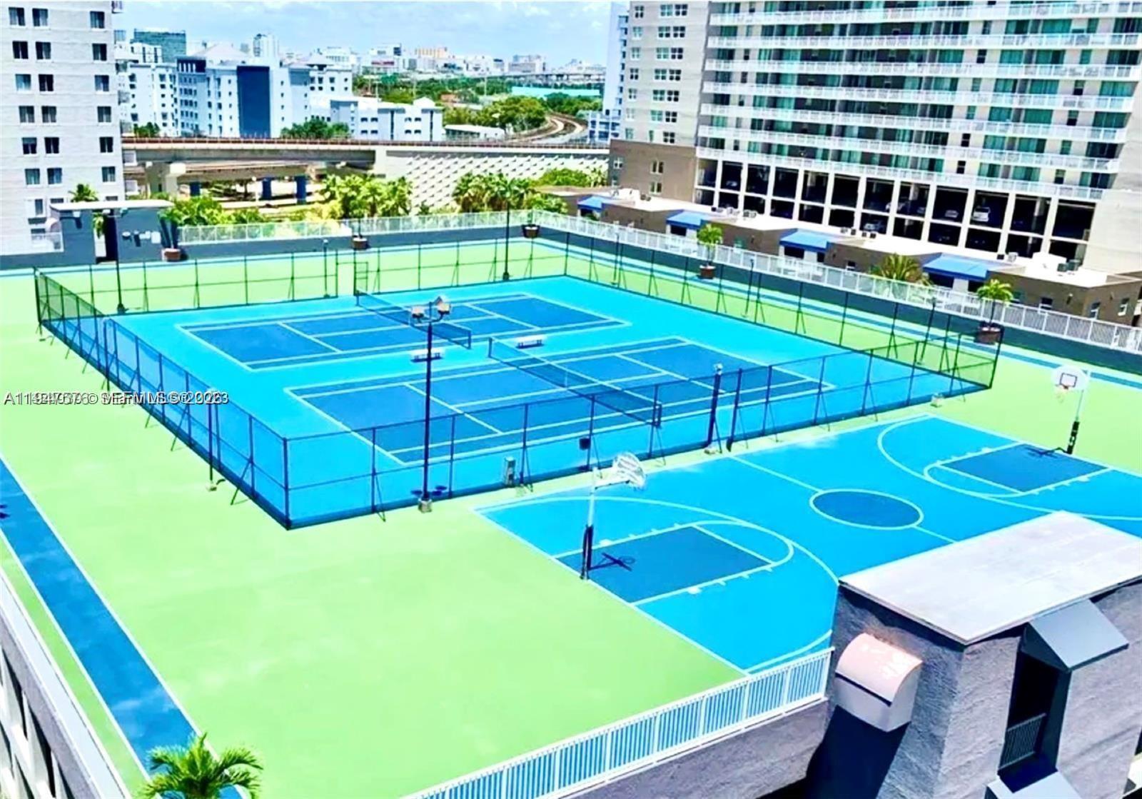 An elevated view shows a blue and green tennis court and basketball court complex — 800 N Miami Ave # 609, Miami FL 33136, MIAMI, FL