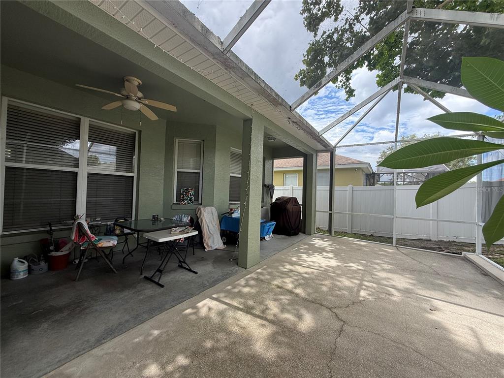 A covered patio features a concrete floor, a ceiling fan, and a screened-in enclosure — 2941 MAPLE GROVE PLACE, OVIEDO, FL