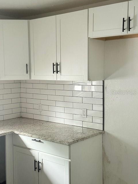 A kitchen features white shaker cabinets, granite countertops, and a white subway tile backsplash — 1717 PROVIDENCE BOULEVARD, DELTONA, FL