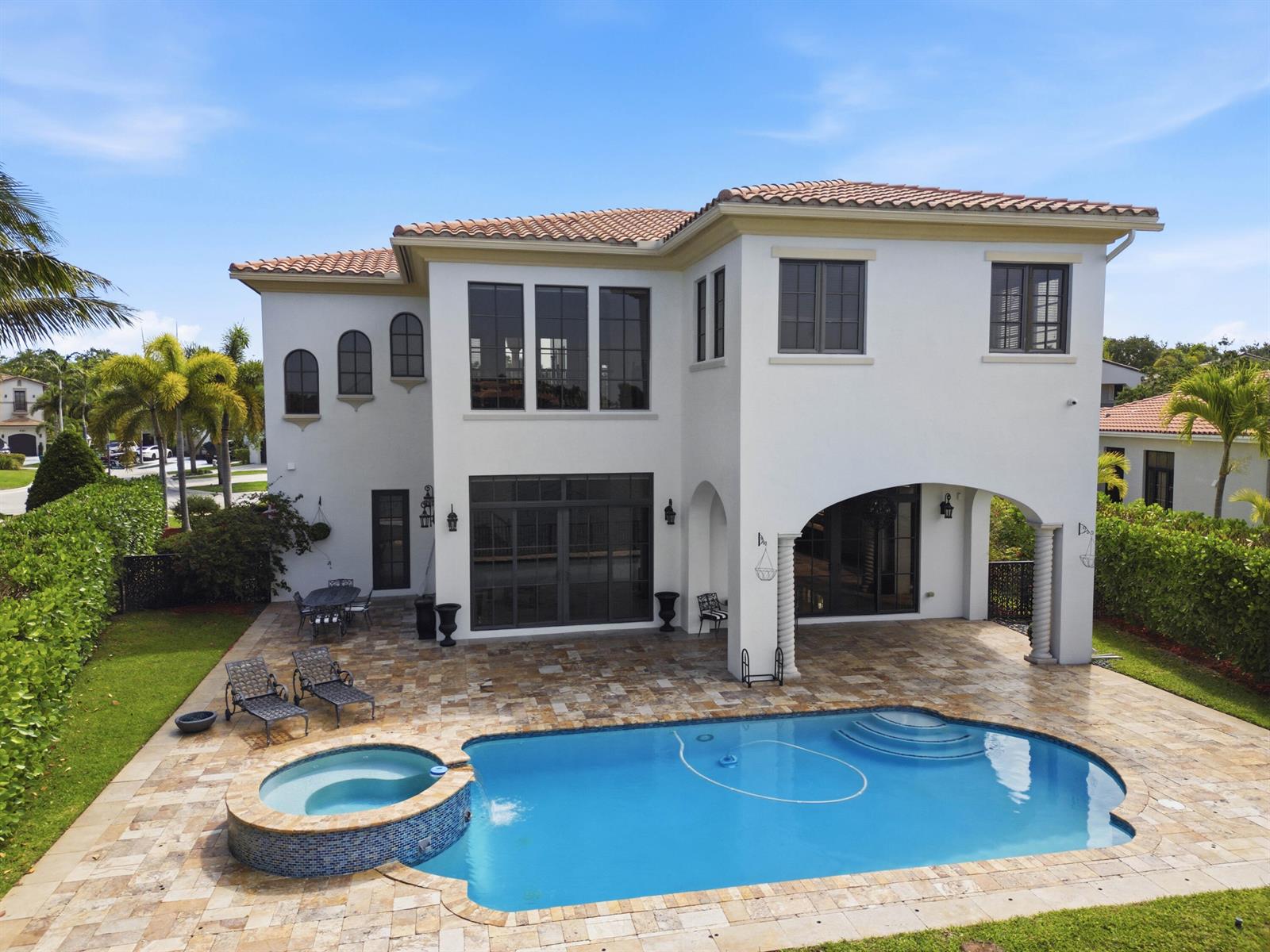 A two-story house with a tiled roof, swimming pool, spa, and stone patio — 8289 Emerald Avenue, Parkland FL 33076, PARKLAND, FL