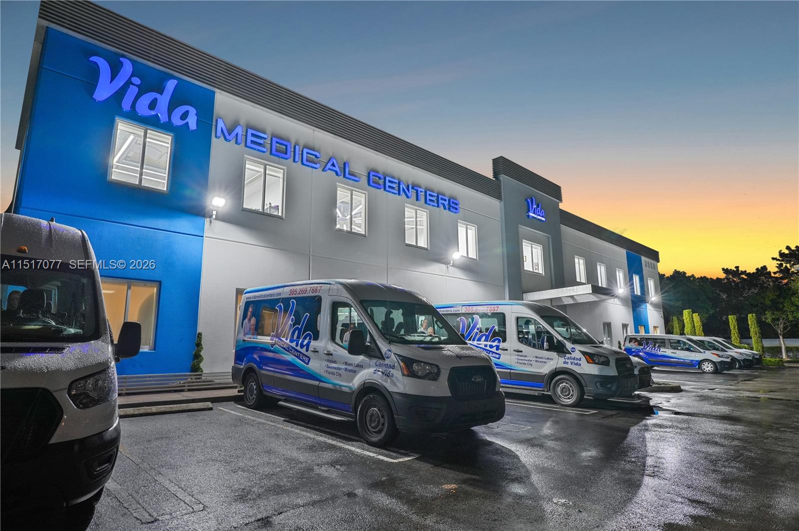The exterior of a Vida Medical Centers building features several branded vans parked in front — 2550 NW 100th Ave, Doral FL 33172, DORAL, FL