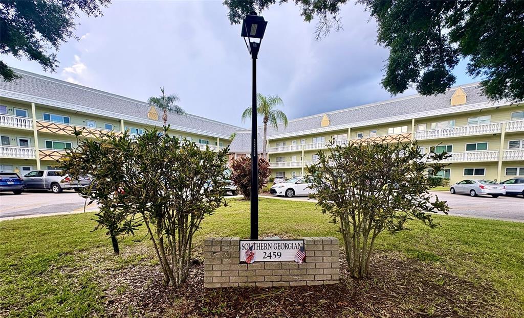 A brick sign for Southern Georgian stands in front of a multi-story apartment complex — 2459 COLUMBIA DRIVE UNIT 69, CLEARWATER, FL