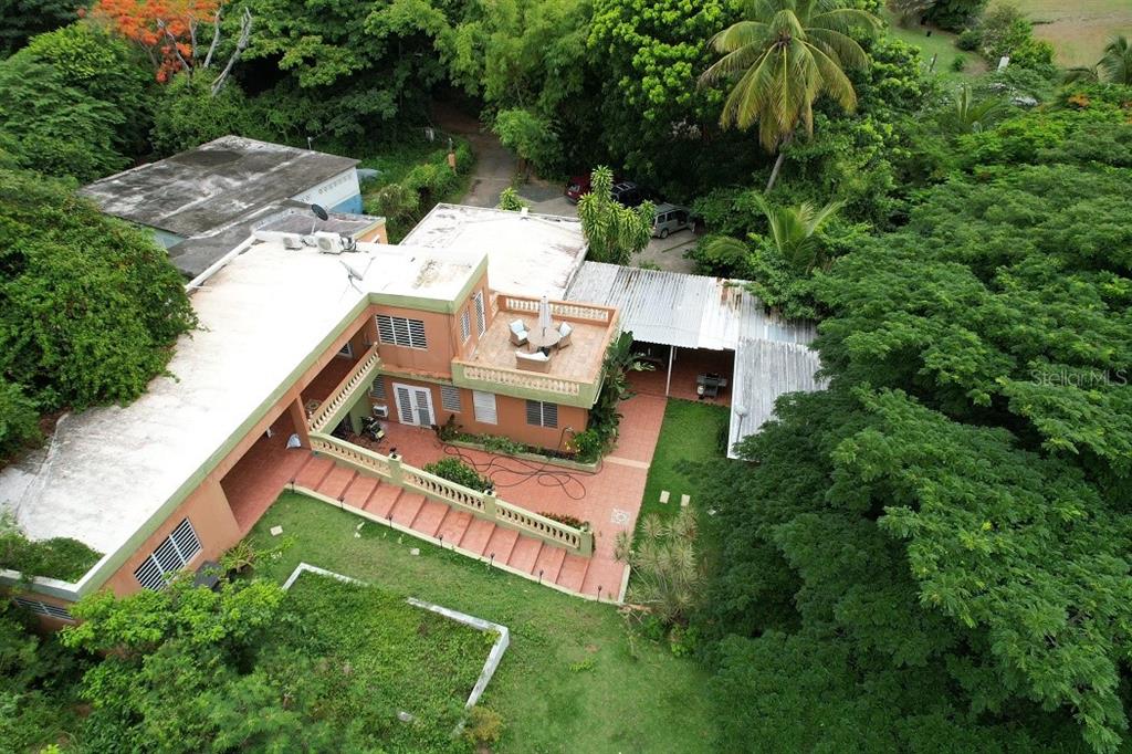 An aerial view shows a multi-level house with a rooftop patio, terrace, and surrounding greenery — 12 Carr 993 DESTINO, VIEQUES, PR