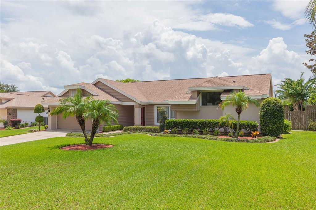 A single-story suburban house with a tan exterior, brown roof, and a front lawn — 1405 OXFORDSHIRE COURT, BRANDON, FL