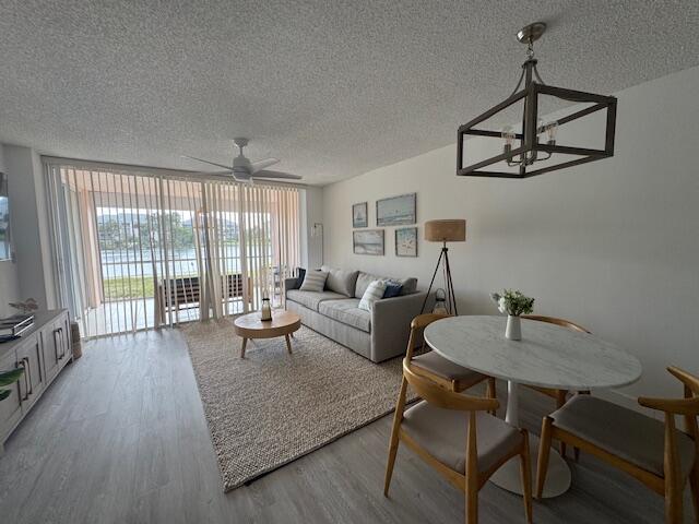 A living and dining room with a sofa, round table, and sliding doors to a patio — 353 S Us Highway 1 # A107, Jupiter FL 33477, JUPITER, FL