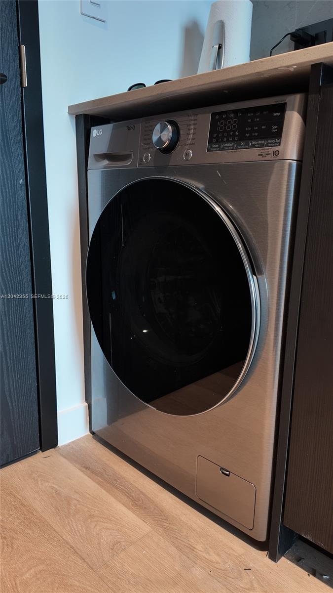 A stainless steel LG front-load washing machine is installed under a countertop in a laundry area — 20 NE 11th St, Miami FL 33132, MIAMI, FL