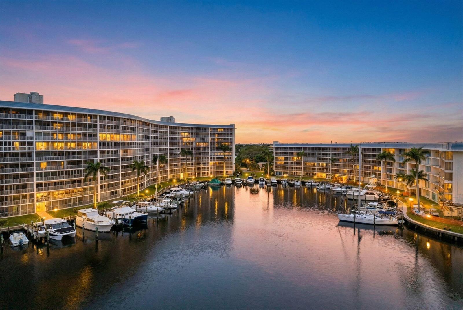 An aerial view of a marina surrounded by multi-story apartment buildings at sunset — 1523 E Hillsboro Boulevard # 634, Deerfield Beach FL 33441, DEERFIELD BEACH, FL