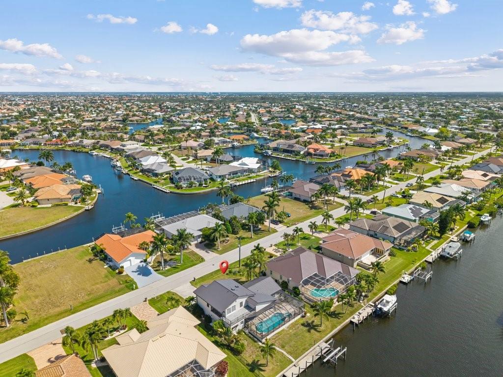 An aerial view of a waterfront house with a pool and boat dock in Florida — 5400 ALMAR DRIVE, PUNTA GORDA, FL