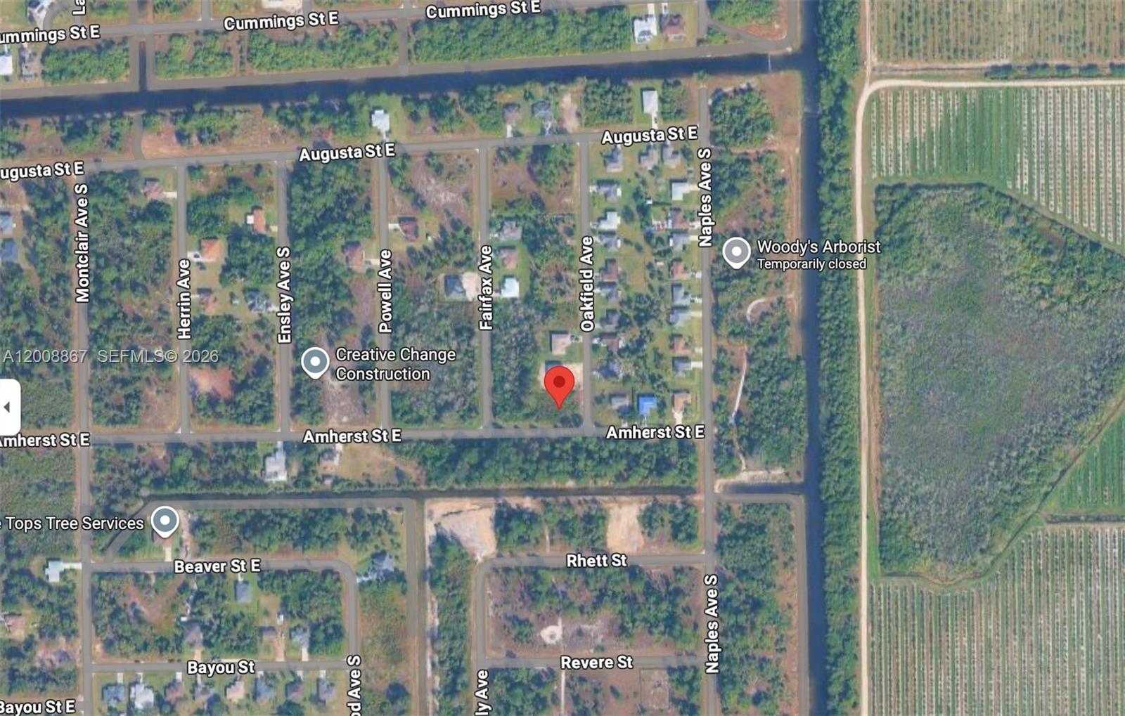 This is a satellite map view showing a residential area with streets and wooded lots — 542 OAKFIELD AVE, Lehigh Acres FL 33974, LEHIGH ACRES, FL