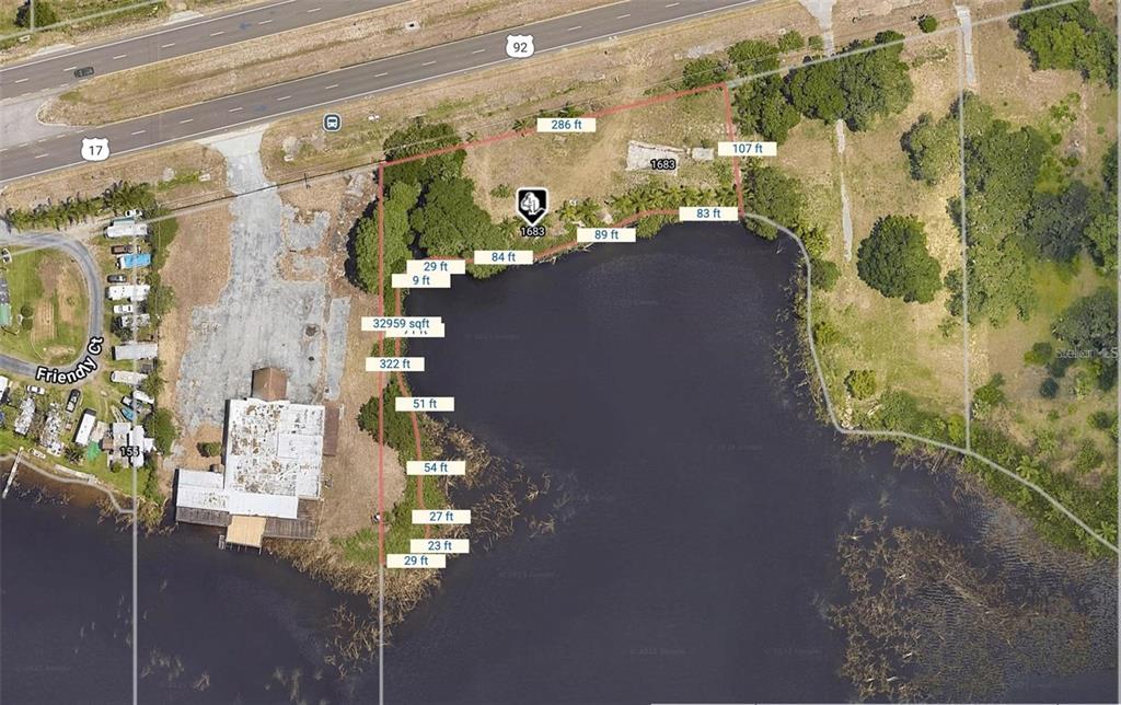 An aerial map shows a waterfront property lot with boundary lines and dimensions overlaid — 1683 US HIGHWAY 17 92, LAKE ALFRED, FL
