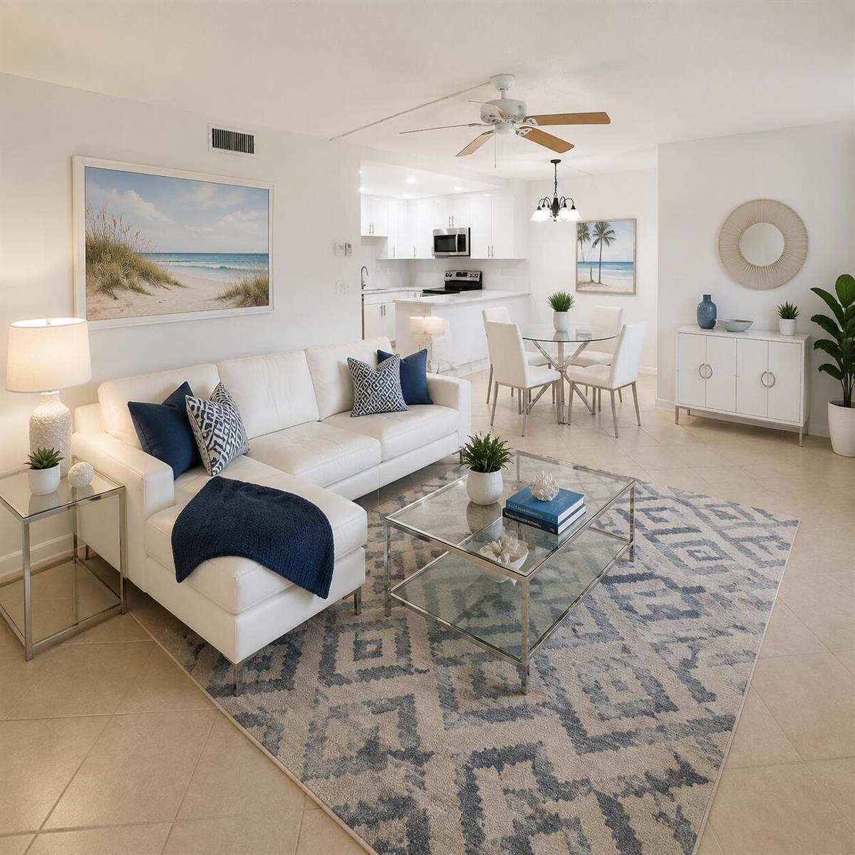 A bright living room features a white sectional sofa, glass coffee table, and dining area — 418 Pine Glen Lane # 1, FL 33463, FL