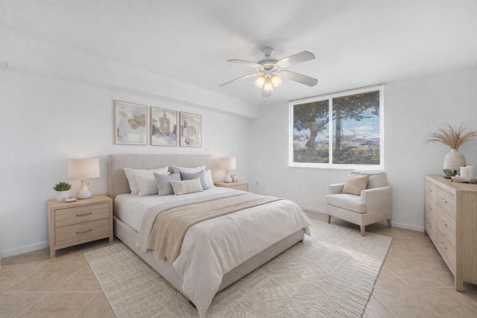 A bright bedroom features a queen bed, light wood furniture, a ceiling fan, and tile flooring — 900 Scotia Drive # 102, Hypoluxo FL 33462, HYPOLUXO, FL