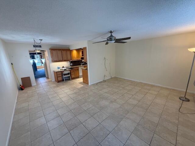 A wide-angle view of an open-concept living area with tile flooring and a ceiling fan — 3092 Westbury H # 3092, Deerfield Beach FL 33442, DEERFIELD BEACH, FL