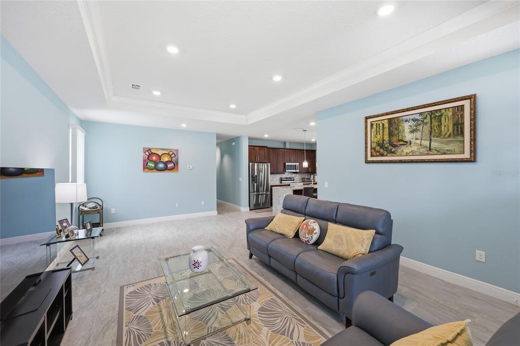 A living room features light blue walls, a tray ceiling, and two white sofas — 2118 W HAMPSHIRE BOULEVARD, CITRUS SPRINGS, FL