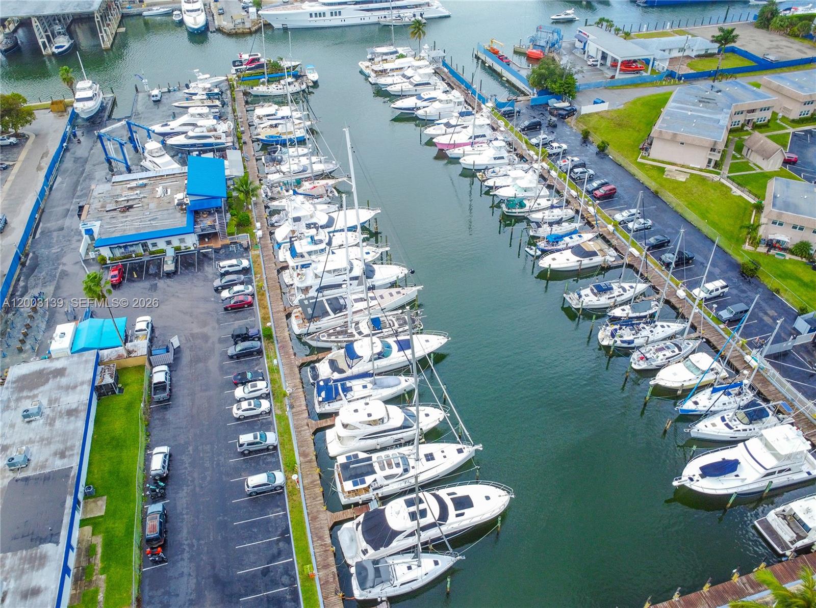 An aerial view shows a marina filled with numerous boats docked in parallel slips — 614 NE 3rd St, Dania Beach FL 33004, DANIA BEACH, FL