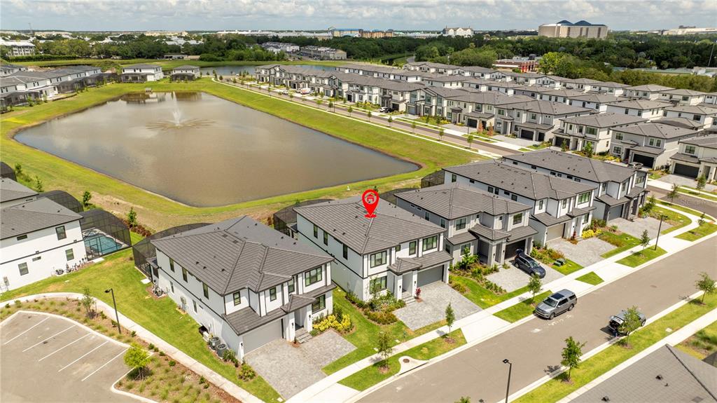 An aerial view shows a two-story house with a red location pin on its roof — 10018 VOYAGER WAY, ORLANDO, FL