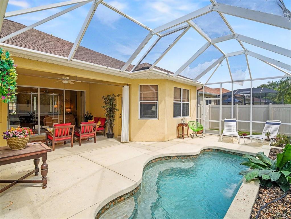 A screened-in patio features a small swimming pool, outdoor seating, and a concrete deck — 11567 57TH STREET CIRCLE E, PARRISH, FL