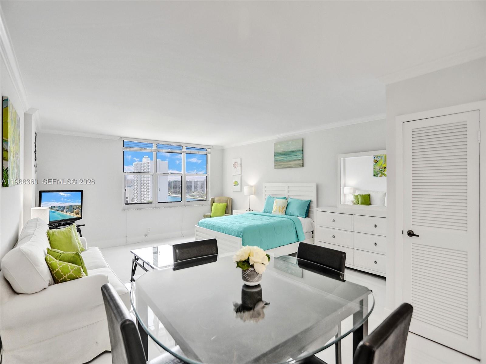 A studio apartment features a bed, dining set, sofa, and a window with water views — 2501 S Ocean Dr, Hollywood FL 33019, HOLLYWOOD, FL