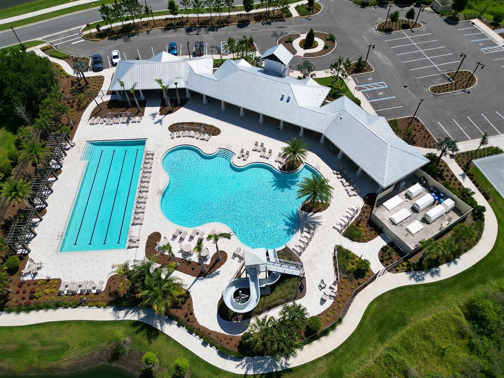 An aerial view shows a community pool complex with a lap pool, slide, and clubhouse — 4008 WESTWOOD FIELDS LOOP, PLANT CITY, FL
