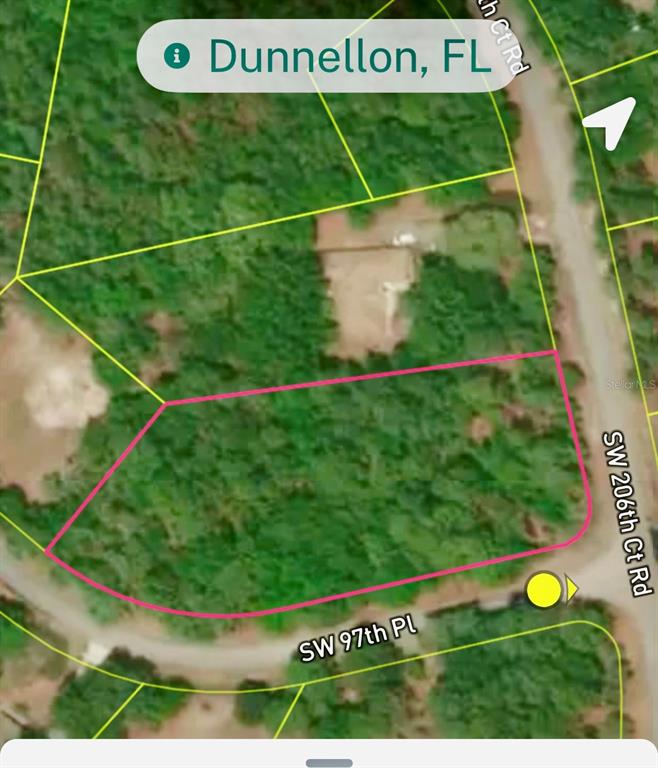 This is a satellite map view showing a vacant, wooded residential lot outlined in pink — Lot 33 SW 97 PLACE, DUNNELLON, FL