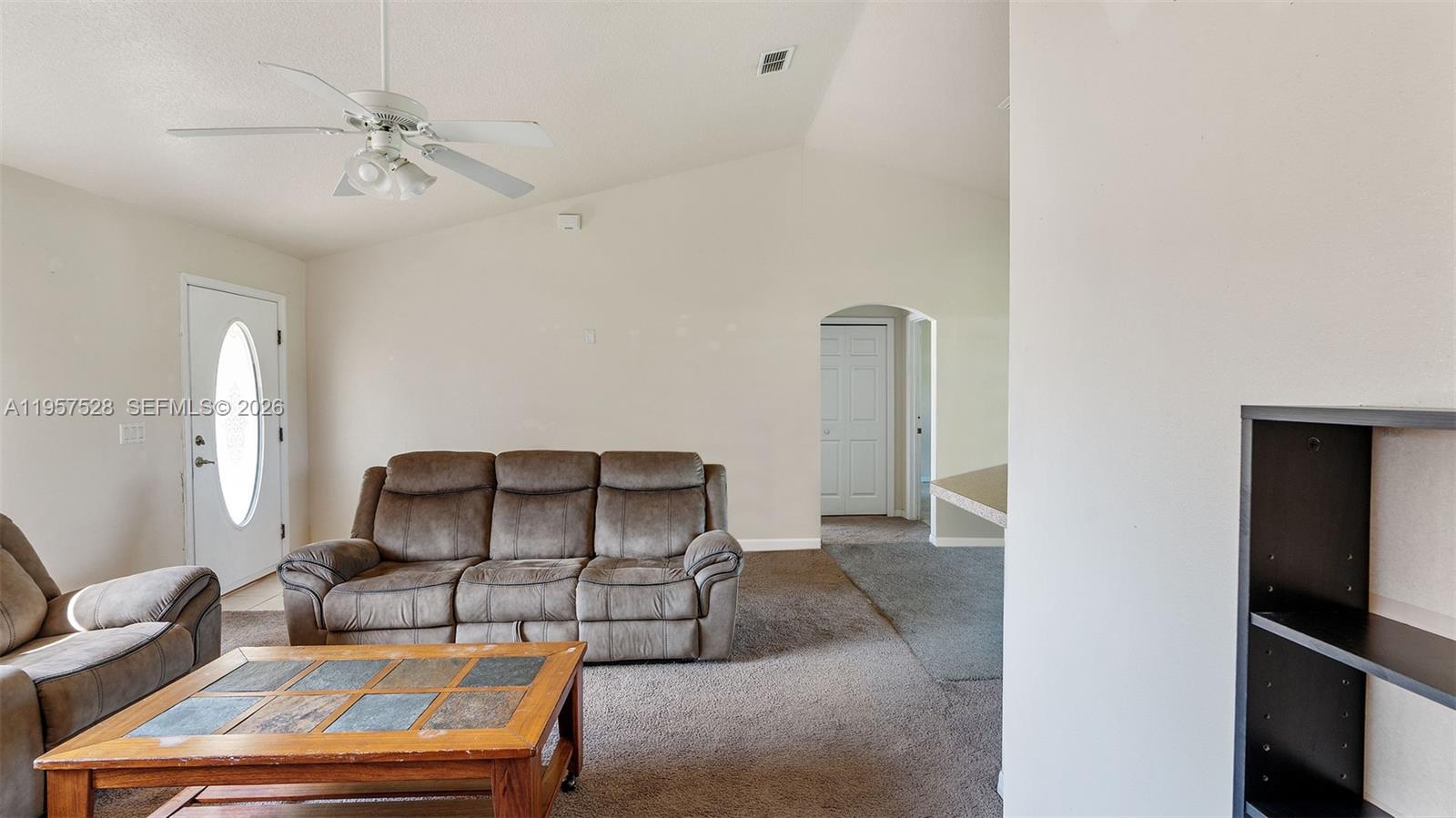 A living room features a brown sofa, a coffee table, and a ceiling fan — 87 Dogwood Drive Circle, Ocala FL 34472, OCALA, FL