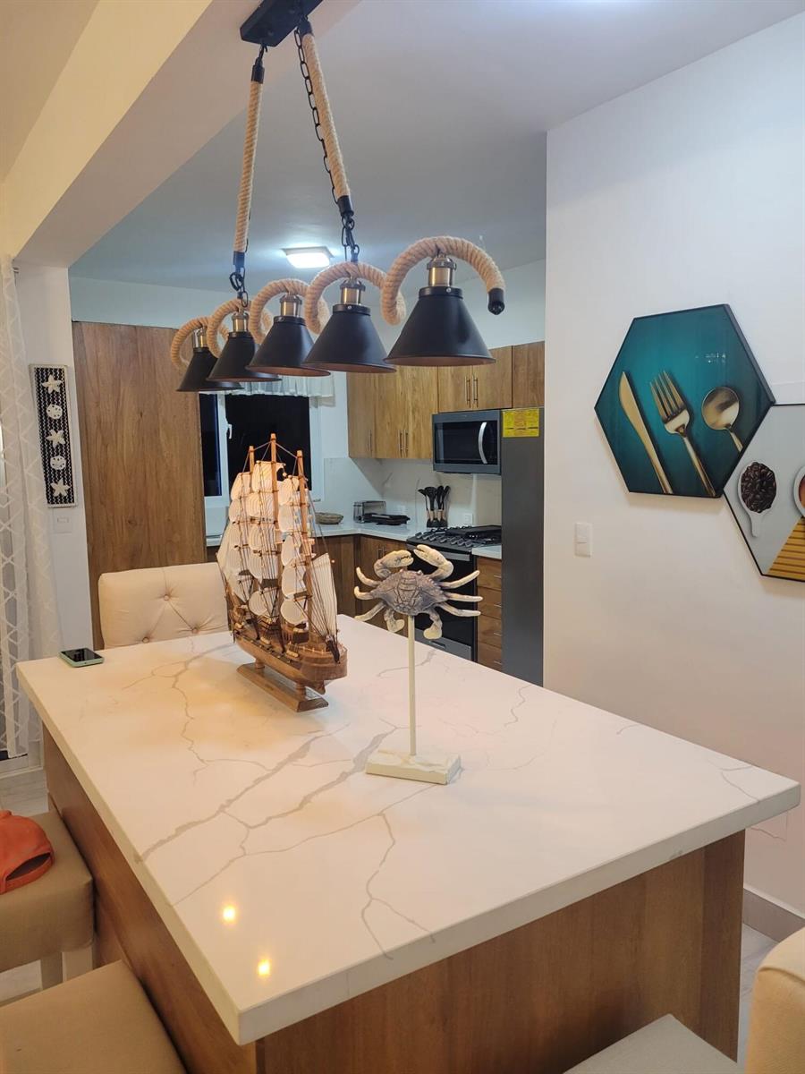 A kitchen island with a white marble countertop, nautical decor, and a rope pendant light — 0 Residencial Coralina # 3, FL